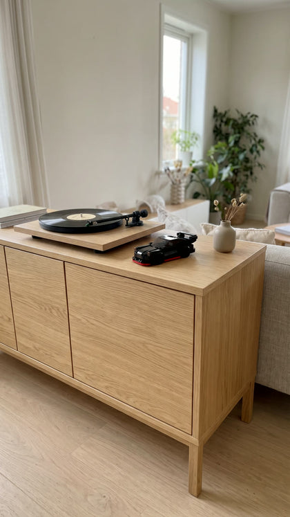 A black brick-built coupe on an oak sideboard next to a record player